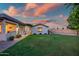 Expansive backyard with lush lawn and covered patio, ideal for entertaining and outdoor living at 15803 W Almeria Rd, Goodyear, AZ 85395