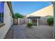 Paver walkway and gravel landscaping in this backyard with privacy fencing at 15803 W Almeria Rd, Goodyear, AZ 85395