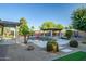 Secluded backyard with a pool, spa, putting green, and shaded pergola, perfect for outdoor enjoyment at 15803 W Almeria Rd, Goodyear, AZ 85395