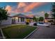 The backyard features a putting green, a pool, and an outdoor kitchen at 15803 W Almeria Rd, Goodyear, AZ 85395