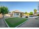 Expansive backyard with putting green, pool, mature landscaping, and covered patio at 15803 W Almeria Rd, Goodyear, AZ 85395