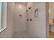 Modern bathroom featuring a large shower with dual shower heads and tiled walls at 15803 W Almeria Rd, Goodyear, AZ 85395