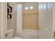 Bathroom including a toilet and a bath tub behind a white curtain with tiled walls at 15803 W Almeria Rd, Goodyear, AZ 85395