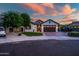 Beautiful single-Gathering home with a well-manicured lawn, classic architecture, and a welcoming entrance at 15803 W Almeria Rd, Goodyear, AZ 85395
