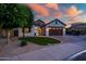 Charming single-Gathering home featuring a well-kept lawn, classic architecture, and a welcoming entrance at 15803 W Almeria Rd, Goodyear, AZ 85395