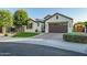 Well-maintained single-Gathering home featuring a manicured lawn, classic architecture, and a welcoming entrance at 15803 W Almeria Rd, Goodyear, AZ 85395