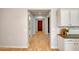 Inviting hallway showcasing wood-look floors, leading to a warm wood front door at 15803 W Almeria Rd, Goodyear, AZ 85395