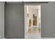 A modern barn door adds character, providing privacy to the bathroom and walk-in closet beyond at 15803 W Almeria Rd, Goodyear, AZ 85395