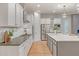Modern kitchen featuring white cabinets, stainless steel appliances, and a spacious island with countertops at 15803 W Almeria Rd, Goodyear, AZ 85395