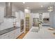 Stylish kitchen with stainless steel appliances, a spacious pantry, and elegant marble countertops at 15803 W Almeria Rd, Goodyear, AZ 85395