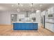 Spacious kitchen with a large island, stainless steel appliances, and sleek hardwood floors at 15803 W Almeria Rd, Goodyear, AZ 85395