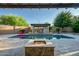 Beautiful pool area, complete with a pergola and a built-in fire pit, great for relaxing at 15803 W Almeria Rd, Goodyear, AZ 85395
