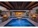 Gorgeous pool with spa and travertine decking, complete with fire bowls and a covered patio at 15803 W Almeria Rd, Goodyear, AZ 85395
