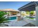 Backyard oasis with pool, fire feature, spa, and pergola, providing the ultimate relaxation space at 15803 W Almeria Rd, Goodyear, AZ 85395