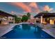 Beautiful backyard featuring a sparkling pool, spa, and two covered patios at 15803 W Almeria Rd, Goodyear, AZ 85395