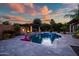 Inviting pool with fire features and relaxing pergola, perfect for outdoor enjoyment and Arizona evenings at 15803 W Almeria Rd, Goodyear, AZ 85395