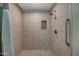 This tile shower features a built-in niche and convenient grab bar at 15803 W Almeria Rd, Goodyear, AZ 85395