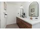 Modern bathroom with dual sinks, wood cabinetry, and bronze fixtures at 1810 W Orchid Ln, Phoenix, AZ 85021