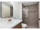 Modern bathroom with a glass-enclosed shower and bronze fixtures at 1810 W Orchid Ln, Phoenix, AZ 85021