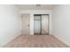Bedroom with neutral walls, carpeting and a mirrored closet at 1810 W Orchid Ln, Phoenix, AZ 85021