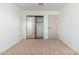 This bedroom features a mirrored closet with neutral walls and carpeting at 1810 W Orchid Ln, Phoenix, AZ 85021