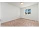 This bedroom offers neutral carpeting and bright white walls at 1810 W Orchid Ln, Phoenix, AZ 85021