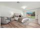 Main bedroom features modern design with a comfortable chair and backyard views at 1810 W Orchid Ln, Phoenix, AZ 85021