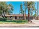 Charming ranch-style home featuring desert landscaping, mature trees, and an attached two-car garage at 1810 W Orchid Ln, Phoenix, AZ 85021