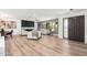 Spacious living room with wood flooring, decorative fireplace, ample seating and a view to the exterior at 1810 W Orchid Ln, Phoenix, AZ 85021