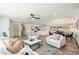 Open-concept living area with wood flooring, modern lighting, seamlessly connecting the kitchen, living, and dining spaces at 1810 W Orchid Ln, Phoenix, AZ 85021