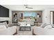 Stylish living room showcasing designer furnishings, natural light, and views of the serene outdoor landscape at 1810 W Orchid Ln, Phoenix, AZ 85021