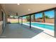 Relaxing covered patio with ceiling fan overlooking a beautiful in-ground pool at 1810 W Orchid Ln, Phoenix, AZ 85021
