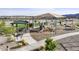 Community playground featuring a covered picnic area, multiple play structures, seating, and paved walkways at 18356 W Gray Fox Trl, Wittmann, AZ 85361