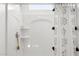 Bright white shower with built-in shelving and a shower curtain with decorative tassels at 18356 W Gray Fox Trl, Wittmann, AZ 85361