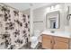 Bathroom featuring a floral shower curtain, tile flooring, and a modern vanity at 20121 N 76Th St # 2021, Scottsdale, AZ 85255