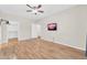Bright bedroom with wood-look floors, ensuite bathroom, and a mounted television at 20121 N 76Th St # 2021, Scottsdale, AZ 85255