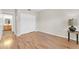 Bright bedroom featuring wood-look floors, a closet, and an adjacent bathroom at 20121 N 76Th St # 2021, Scottsdale, AZ 85255