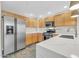 Kitchen featuring stainless steel appliances, white countertops, and wood cabinets for ample storage at 20121 N 76Th St # 2021, Scottsdale, AZ 85255