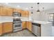 Well-lit kitchen featuring stainless steel appliances, light wood cabinets, and a sleek countertop at 20121 N 76Th St # 2021, Scottsdale, AZ 85255