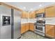 Updated kitchen featuring stainless steel appliances, white countertops, and wooden cabinets at 20121 N 76Th St # 2021, Scottsdale, AZ 85255