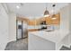 Bright kitchen featuring white countertops, wood cabinets, stainless steel appliances and pendant lighting at 20121 N 76Th St # 2021, Scottsdale, AZ 85255