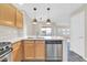 Bright kitchen with stainless steel dishwasher, modern countertop, and view into the living area at 20121 N 76Th St # 2021, Scottsdale, AZ 85255