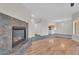 Open-concept living space featuring a stone fireplace, hardwood floors, and views of the kitchen at 20121 N 76Th St # 2021, Scottsdale, AZ 85255