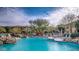Beautiful community pool featuring poolside seating, stone accents, and well-maintained landscaping at 20121 N 76Th St # 2021, Scottsdale, AZ 85255