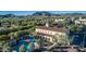 Aerial view of the community center featuring a pool, palm trees, and surrounding neighborhood at 20576 W Briarwood Dr, Buckeye, AZ 85396