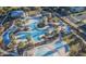 Aerial view of the community pool featuring multiple pools, sun loungers, and palm trees for resort-style living at 20576 W Briarwood Dr, Buckeye, AZ 85396