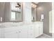 A bathroom with double sinks, granite countertops and white cabinets at 20576 W Briarwood Dr, Buckeye, AZ 85396