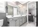 Bathroom features double sinks, neutral walls, white cabinets, and vanity lighting at 20576 W Briarwood Dr, Buckeye, AZ 85396