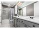 Updated bathroom featuring double sinks, neutral walls, white cabinets, and tiled shower at 20576 W Briarwood Dr, Buckeye, AZ 85396