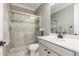 Updated bathroom featuring double sinks, vanity, and walk-in shower with glass door at 20576 W Briarwood Dr, Buckeye, AZ 85396